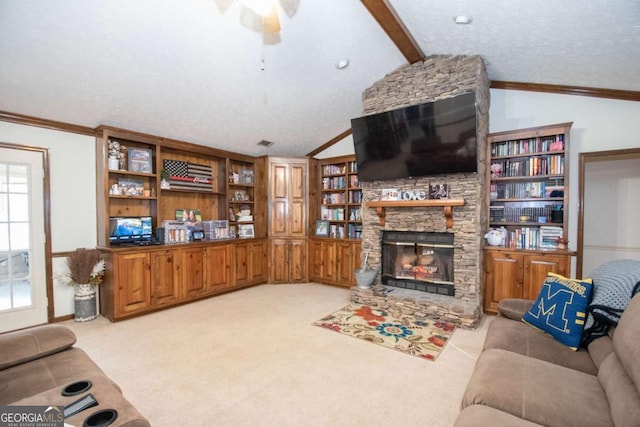 carpeted living room with ornamental molding, a textured ceiling, ceiling fan, lofted ceiling with beams, and a fireplace