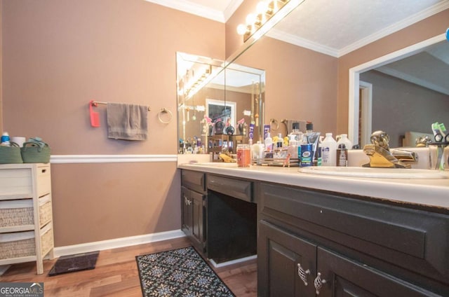 bathroom with hardwood / wood-style floors, vanity, and ornamental molding