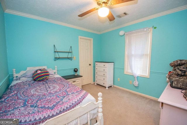 carpeted bedroom featuring ceiling fan, crown molding, and a textured ceiling