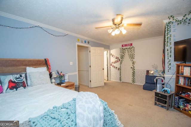 carpeted bedroom featuring a textured ceiling, ceiling fan, and ornamental molding