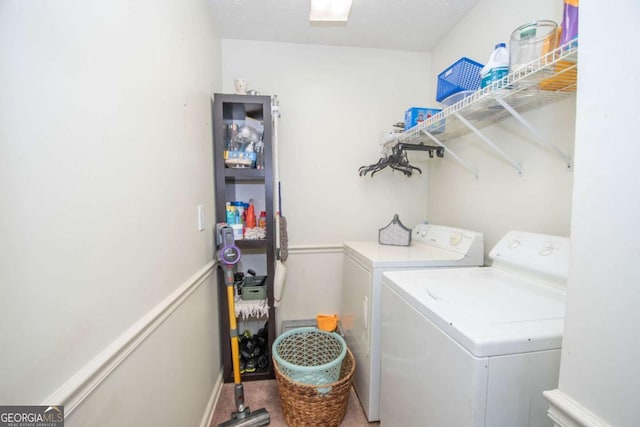 clothes washing area featuring separate washer and dryer