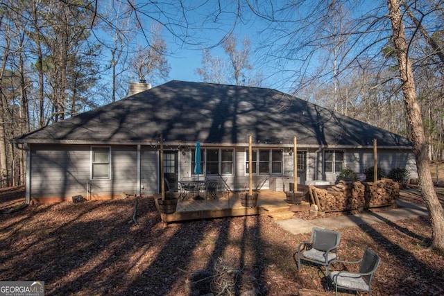 rear view of house with a wooden deck