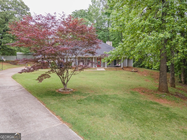 306 Washington Way, Lagrange, GA 30240 - view of front facade featuring a chimney, a porch, a front lawn, and driveway