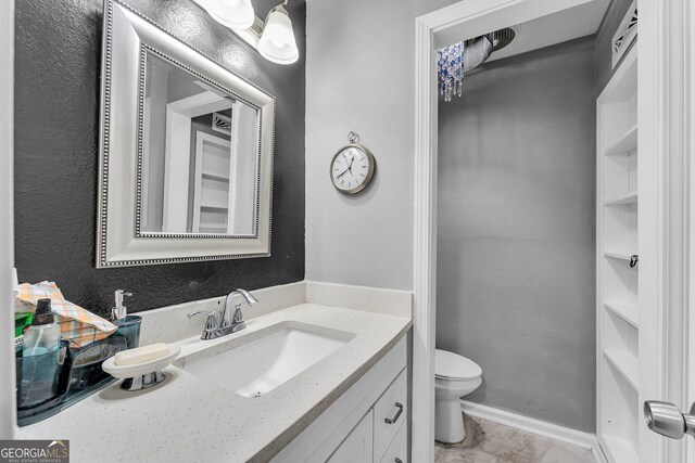 bathroom with vanity and toilet