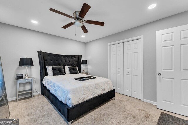 carpeted bedroom with ceiling fan and a closet