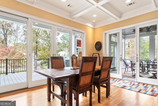 dining room with french doors, coffered ceiling, crown molding, light wood-type flooring, and beam ceiling