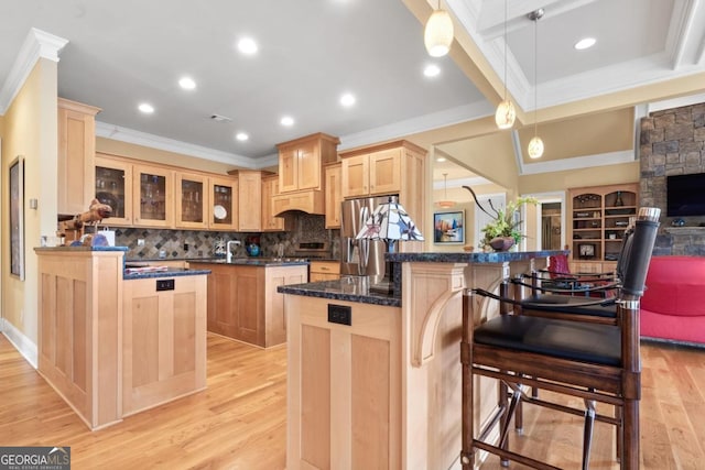 kitchen with a breakfast bar, a center island, kitchen peninsula, and hanging light fixtures