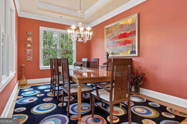 dining room featuring a chandelier, crown molding, and a tray ceiling