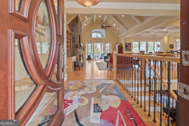 hallway with vaulted ceiling with beams and light hardwood / wood-style flooring