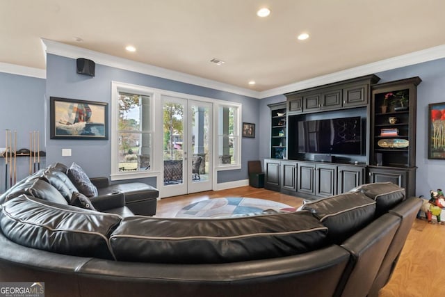 living room featuring french doors, light wood-type flooring, and ornamental molding