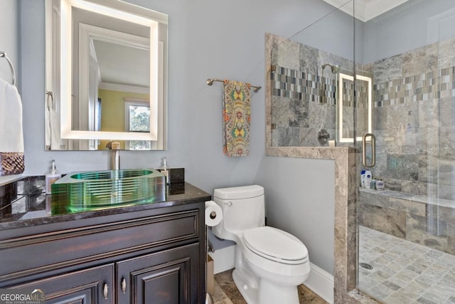 bathroom with vanity, toilet, ornamental molding, and walk in shower