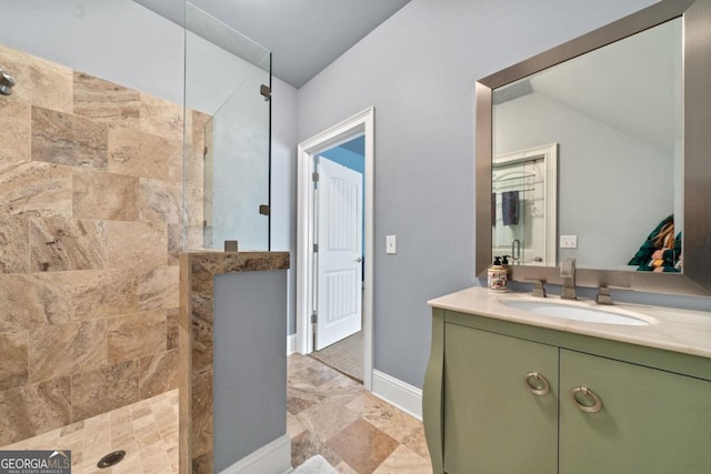 bathroom with vanity and tiled shower