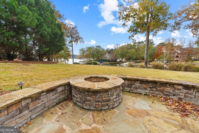 view of patio / terrace with a water view and an outdoor fire pit