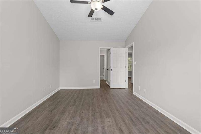 unfurnished bedroom featuring ceiling fan, dark hardwood / wood-style flooring, and vaulted ceiling