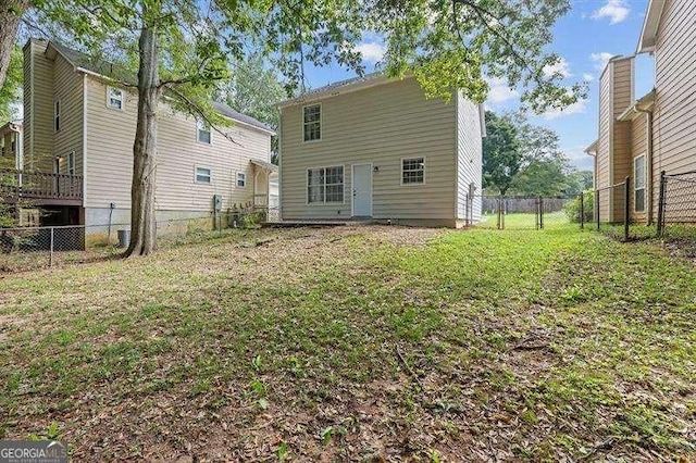 back of house with a lawn