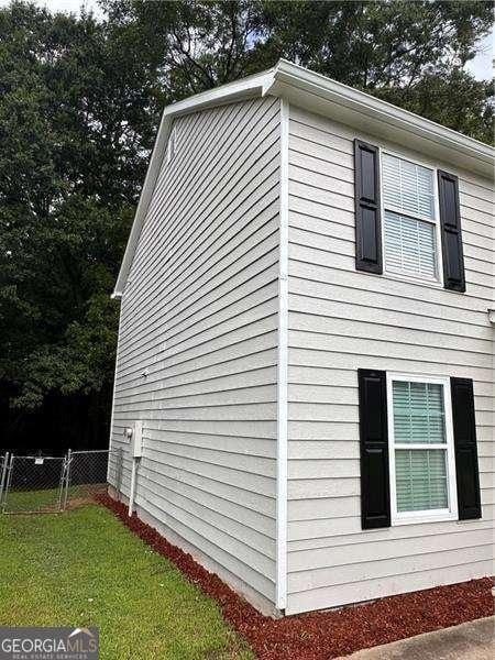 view of property exterior featuring a lawn