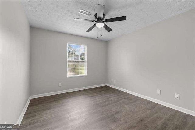 unfurnished room with a textured ceiling, dark hardwood / wood-style flooring, and ceiling fan