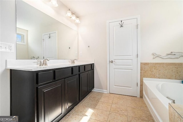 bathroom with tile patterned flooring, vanity, and a bath