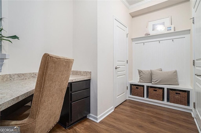 mudroom featuring crown molding and dark wood-type flooring