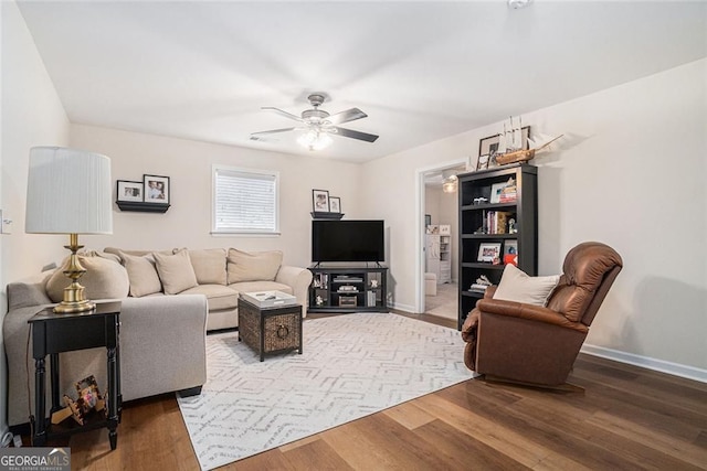 living room with hardwood / wood-style flooring and ceiling fan