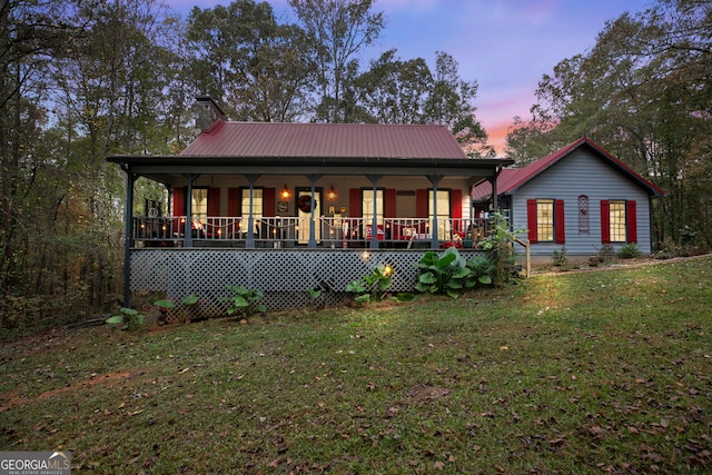 view of front of home with a yard and a porch