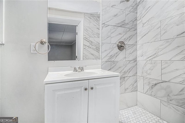 bathroom with vanity and tiled shower