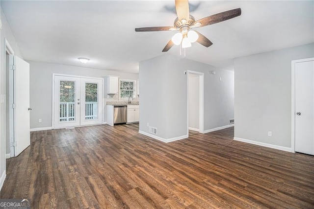 unfurnished living room featuring ceiling fan, french doors, and dark wood-type flooring