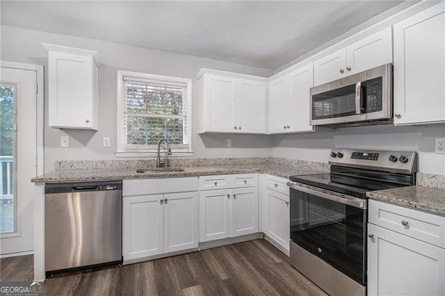 kitchen featuring white cabinets, stainless steel appliances, and sink