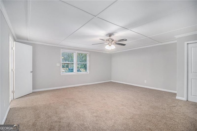 carpeted empty room featuring ceiling fan and ornamental molding