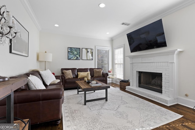 living room featuring a fireplace, hardwood / wood-style floors, and ornamental molding