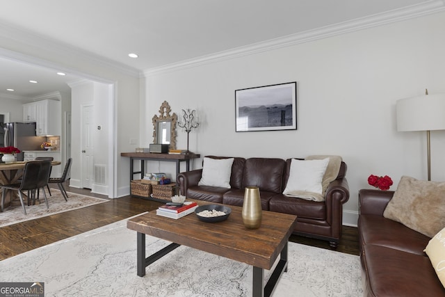 living room featuring hardwood / wood-style flooring and crown molding