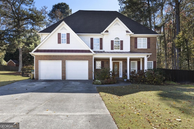 view of property featuring a porch, a garage, and a front yard