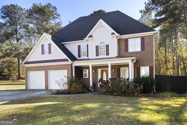 view of front of house with a front yard, a porch, and a garage