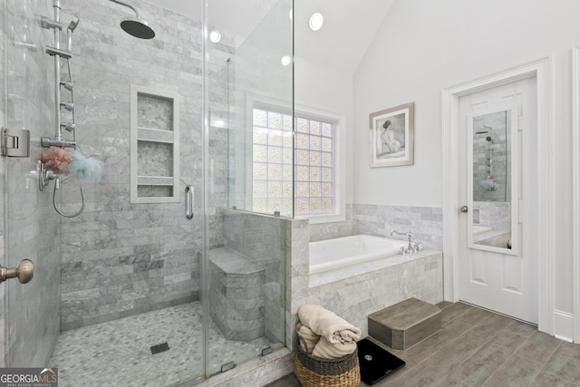 bathroom with vaulted ceiling and separate shower and tub