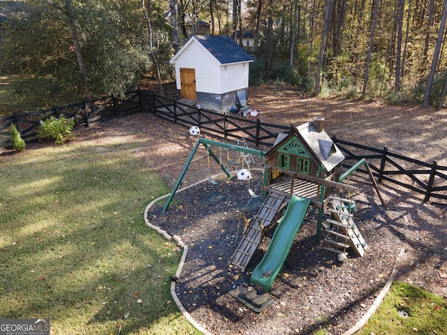 view of yard featuring a playground and a shed