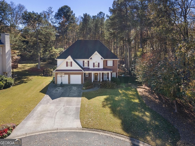 view of front of house with a front yard and a garage