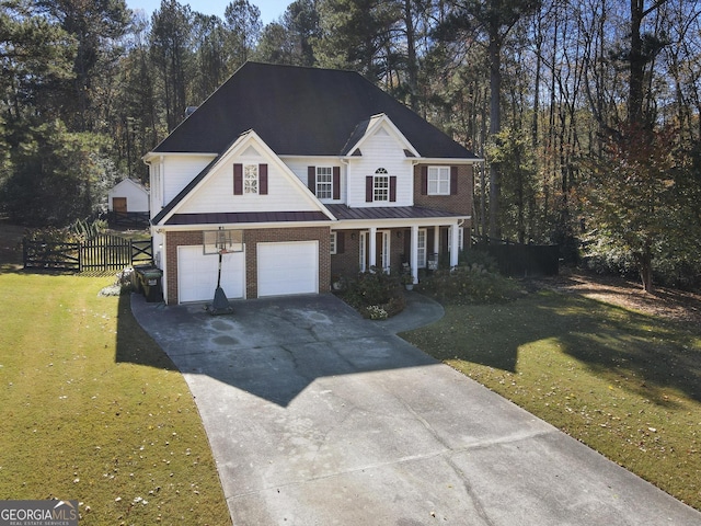 view of front of property with covered porch, a front yard, and a garage