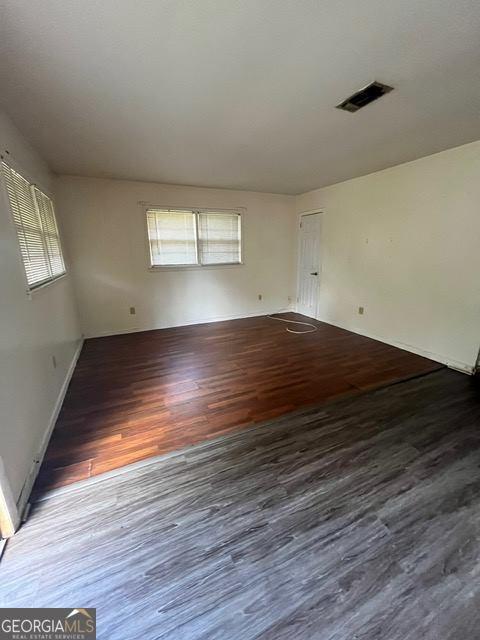 spare room featuring dark hardwood / wood-style floors