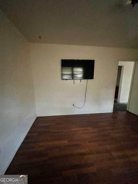 empty room featuring dark wood-type flooring