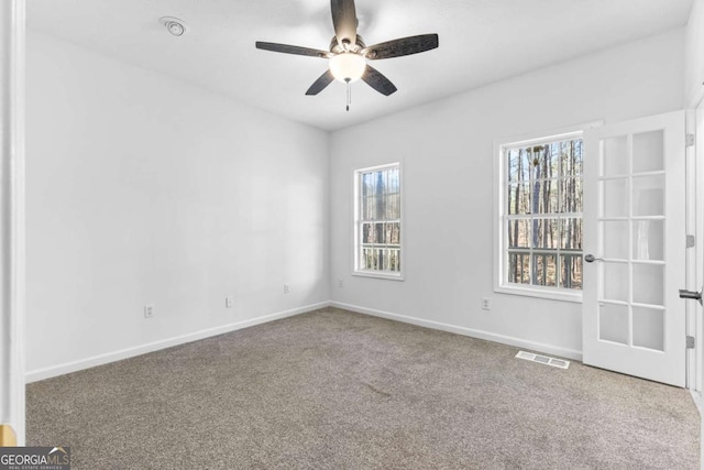 carpeted empty room with ceiling fan