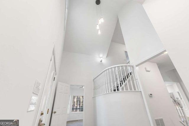 staircase featuring a towering ceiling