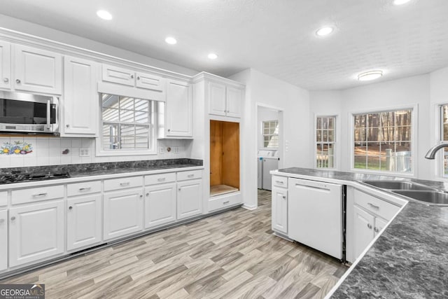 kitchen featuring white cabinetry, dishwasher, sink, gas cooktop, and light hardwood / wood-style flooring