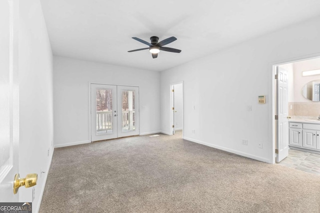 unfurnished room featuring ceiling fan, light carpet, and french doors