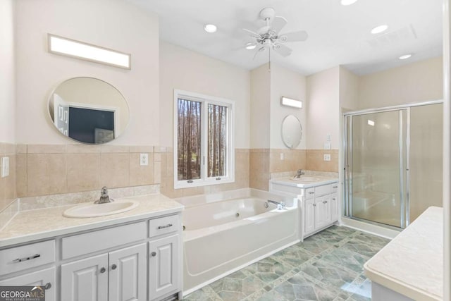 bathroom featuring ceiling fan, vanity, and independent shower and bath