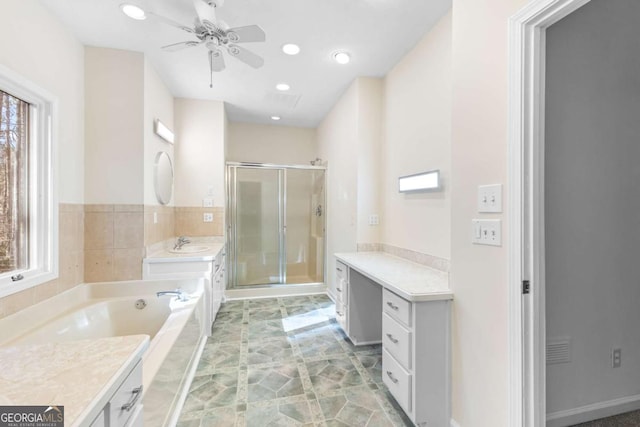 bathroom with plus walk in shower, vanity, and ceiling fan