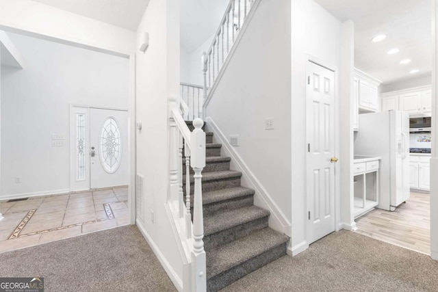 foyer with light colored carpet