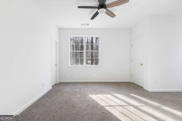 empty room with carpet and ceiling fan