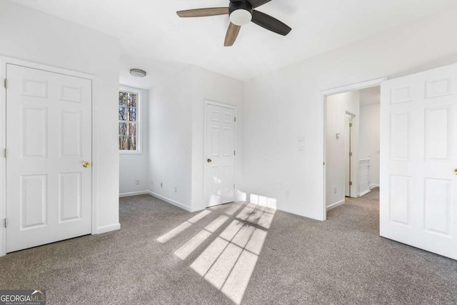 unfurnished bedroom with ceiling fan and carpet floors