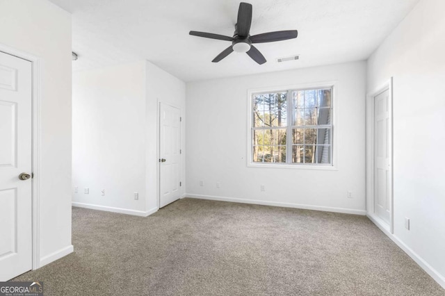 unfurnished bedroom featuring carpet and ceiling fan