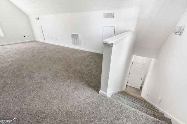 interior space featuring carpet and lofted ceiling